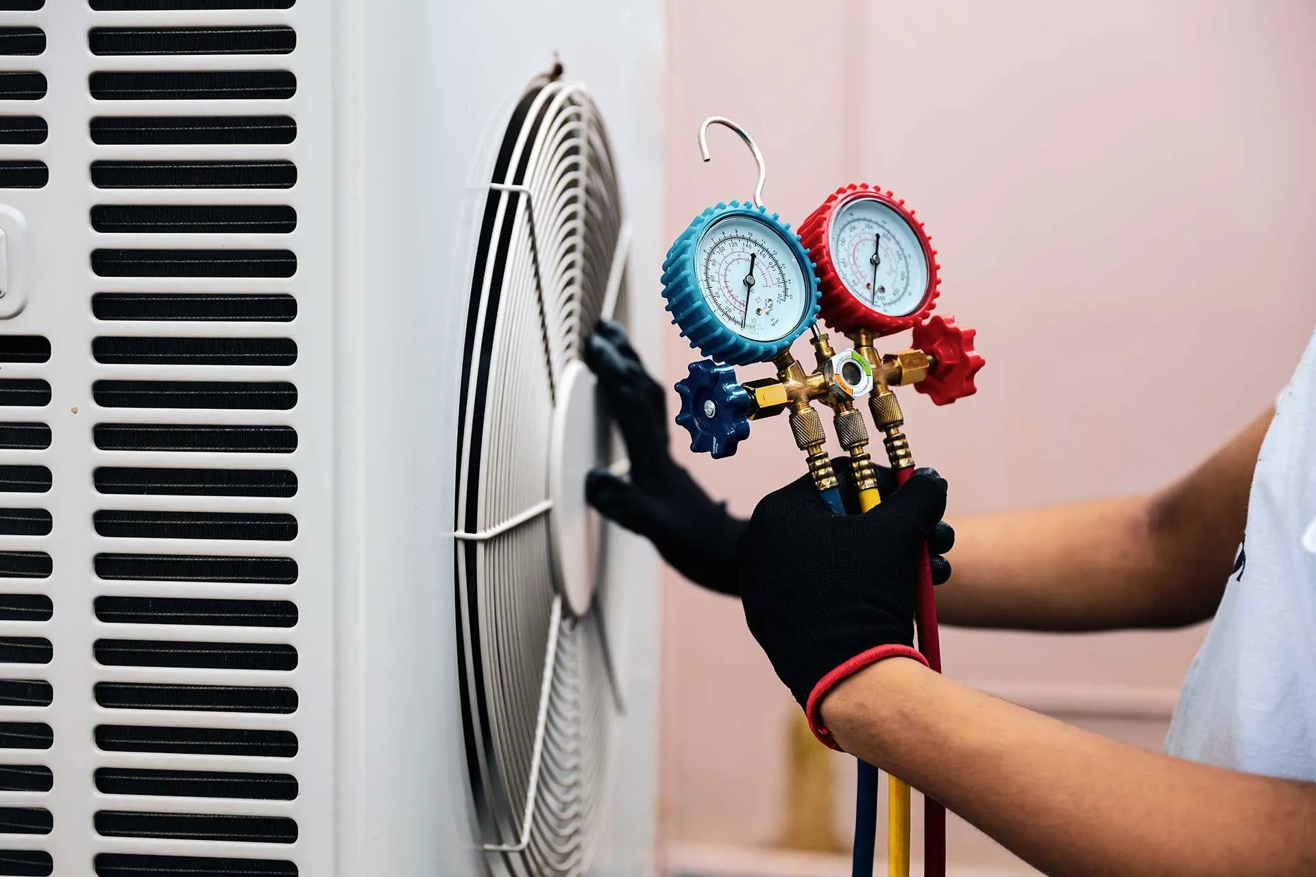 HVAC technician checking an outdoor air conditioning system during diagnostics